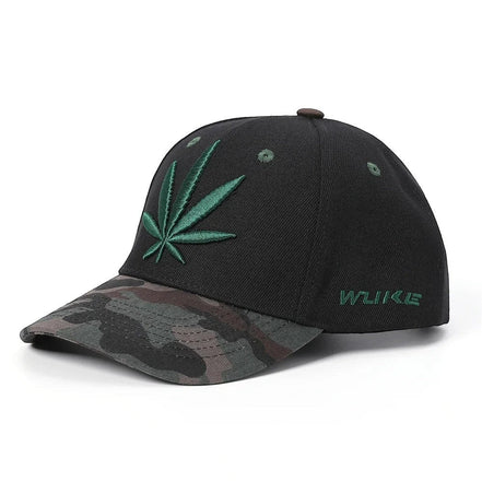 AKJ Fashion black polyester baseball cap with green cannabis leaf embroidery and camouflage brim. Adjustable strap.