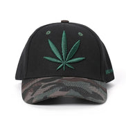 AKJ Fashion black polyester baseball cap with green cannabis leaf embroidery and camouflage brim. Adjustable strap.