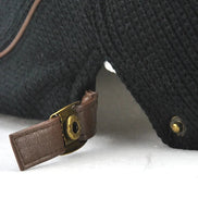 AKJ Fashion men's black knit beret with leather strap and brass hardware, vintage style.
