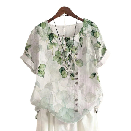 AKJ Fashion blouse verte à imprimé feuilles d'eucalyptus, col rond, manches courtes retroussées, boutonnage décalé.