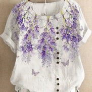 AKJ Fashion blouse blanche à imprimé glycines violettes et papillons, effet lin, manches courtes retroussées, boutonnage décalé.