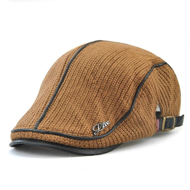 AKJ Fashion brown knit flat cap with faux leather trim and "Love" emblem. Adjustable strap at back.