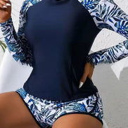 Ensemble anti-UV AKJ Fashion 2 pièces: top marine manches longues et short imprimé feuilles bleues. Protection UPF 50+.