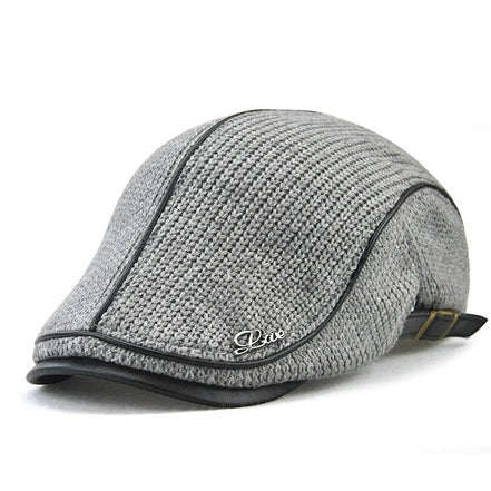 AKJ Fashion grey knit flat cap with faux leather trim and decorative 'Live' emblem. Adjustable strap at back.
