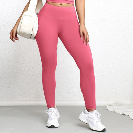 Legging rose vif AKJ Fashion avec poches latérales, coupe ajustée et tissu résistant pour le sport ou le quotidien.