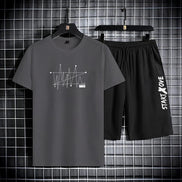 AKJ Fashion men's dark grey t-shirt and black shorts set with graphic print and text detail. Quick-dry athletic wear.