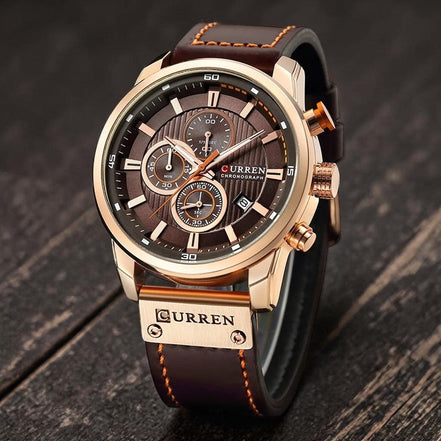 Montre chronographe CURREN homme en acier inoxydable doré, cadran marron avec 3 sous-compteurs et bracelet en cuir marron.