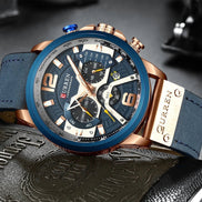 Montre AKJ Fashion CURREN chronographe bleu marine avec bracelet en cuir bleu et boîtier or rose. Style urbain.