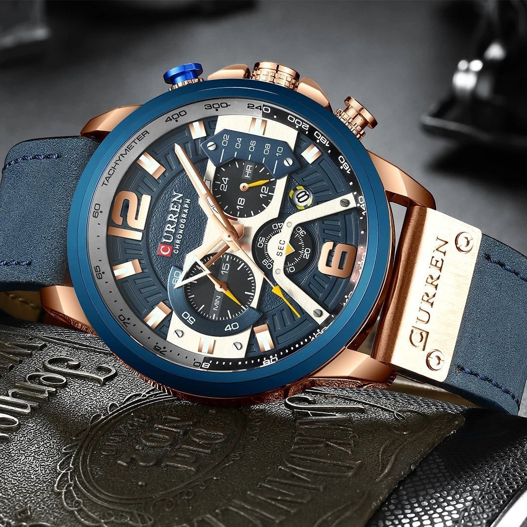Montre AKJ Fashion CURREN chronographe bleu marine avec bracelet en cuir bleu et boîtier or rose. Style urbain.