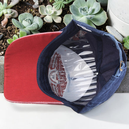 AKJ Fashion navy blue cotton baseball cap with red underside and embroidered detail. Adjustable strap.