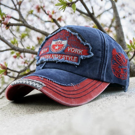 AKJ Fashion vintage distressed blue denim baseball cap with red accents and New York embroidery. Adjustable strap for adult unisex wear.