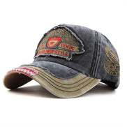 AKJ Fashion distressed charcoal denim baseball cap with embroidered New York patches and adjustable strap.